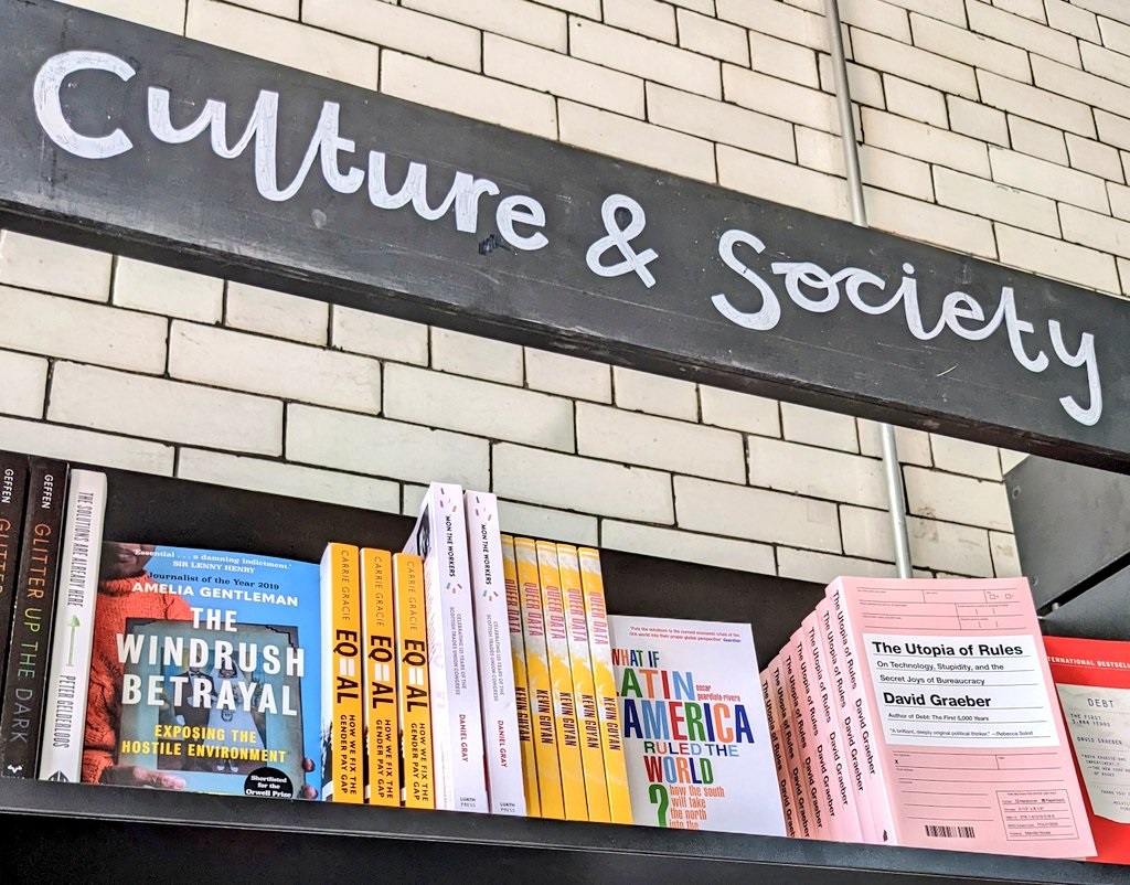 A book shelf in a book store, on the shelf are multiple copies of Queer Data.
